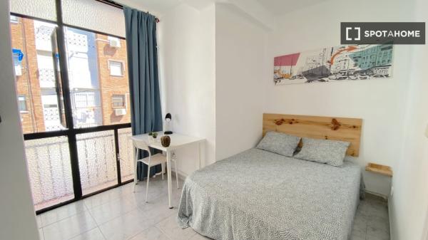 Bright room with double bed equipped for students