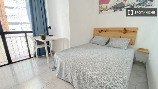 Bright room with double bed equipped for students